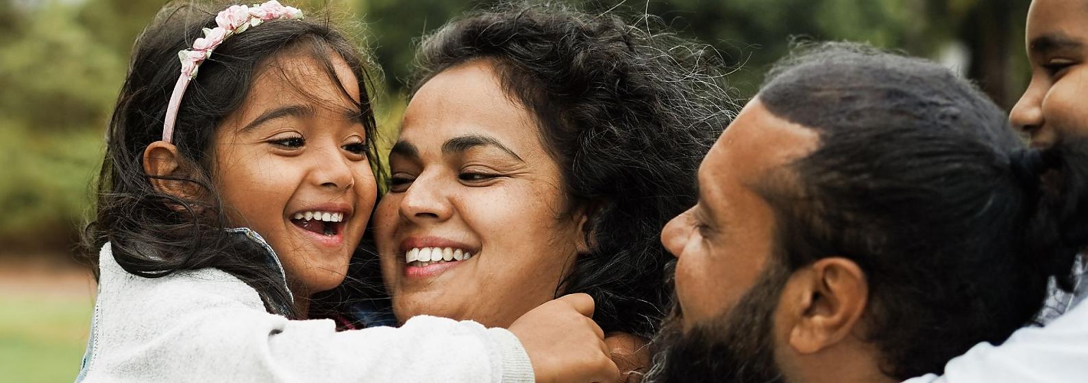 Family laughing outdoors