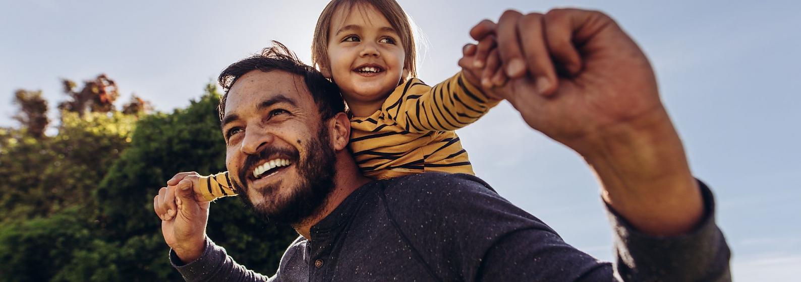 Child on man's shoulders