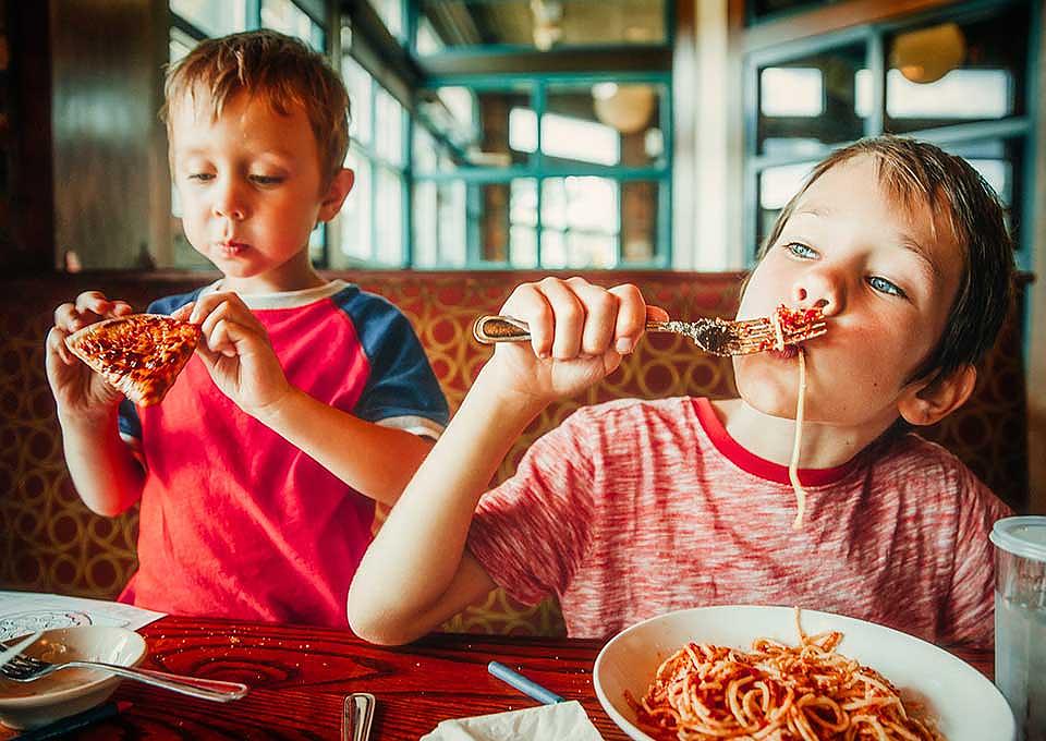 Kids eating spaghetti